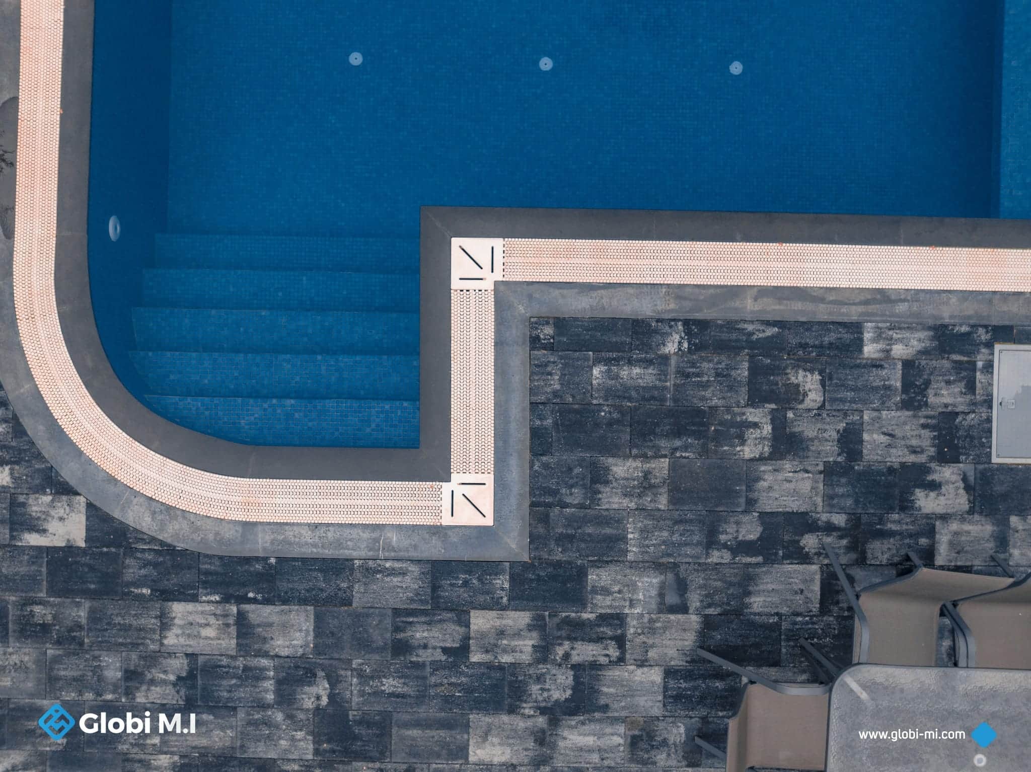 Paved surface at the edge of a swimming pool.