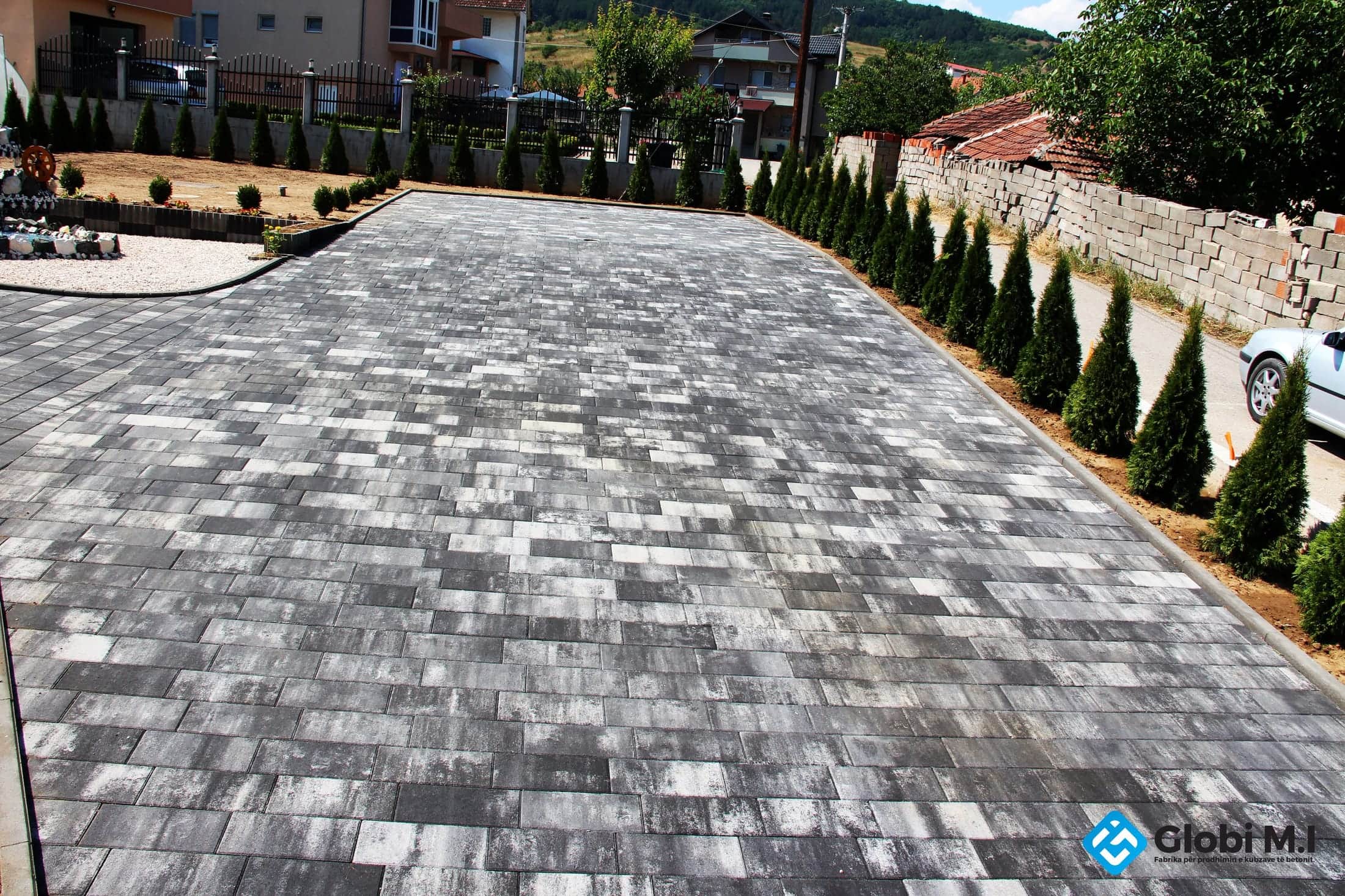 Wide paved surface of rectangular concrete elements.