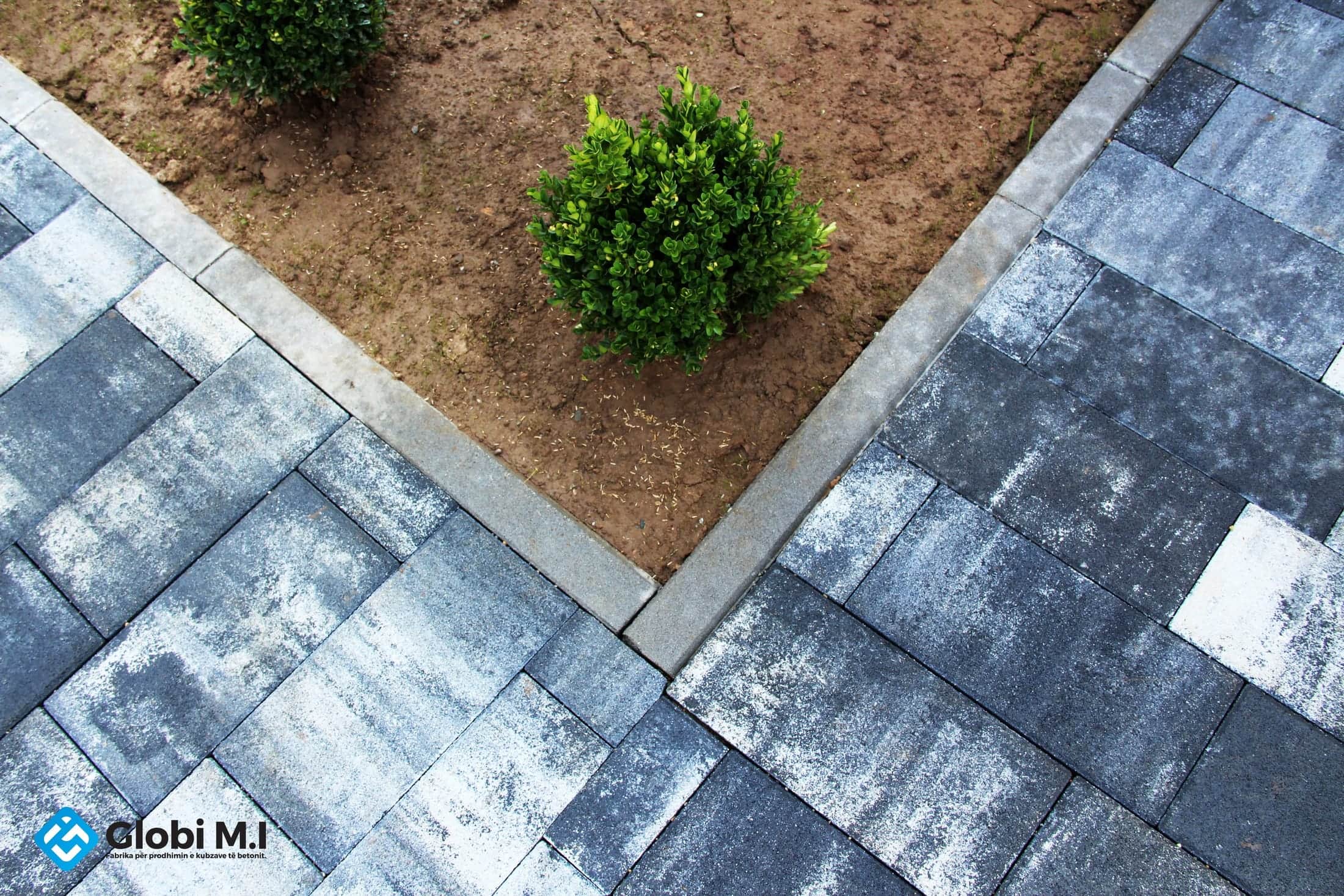 Concrete paving laid diagonally, in mixed tones.