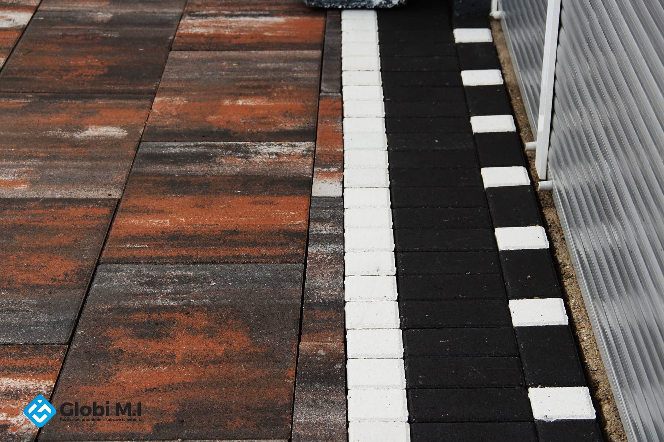 The paving meeting a pale edging with a contrasting course.