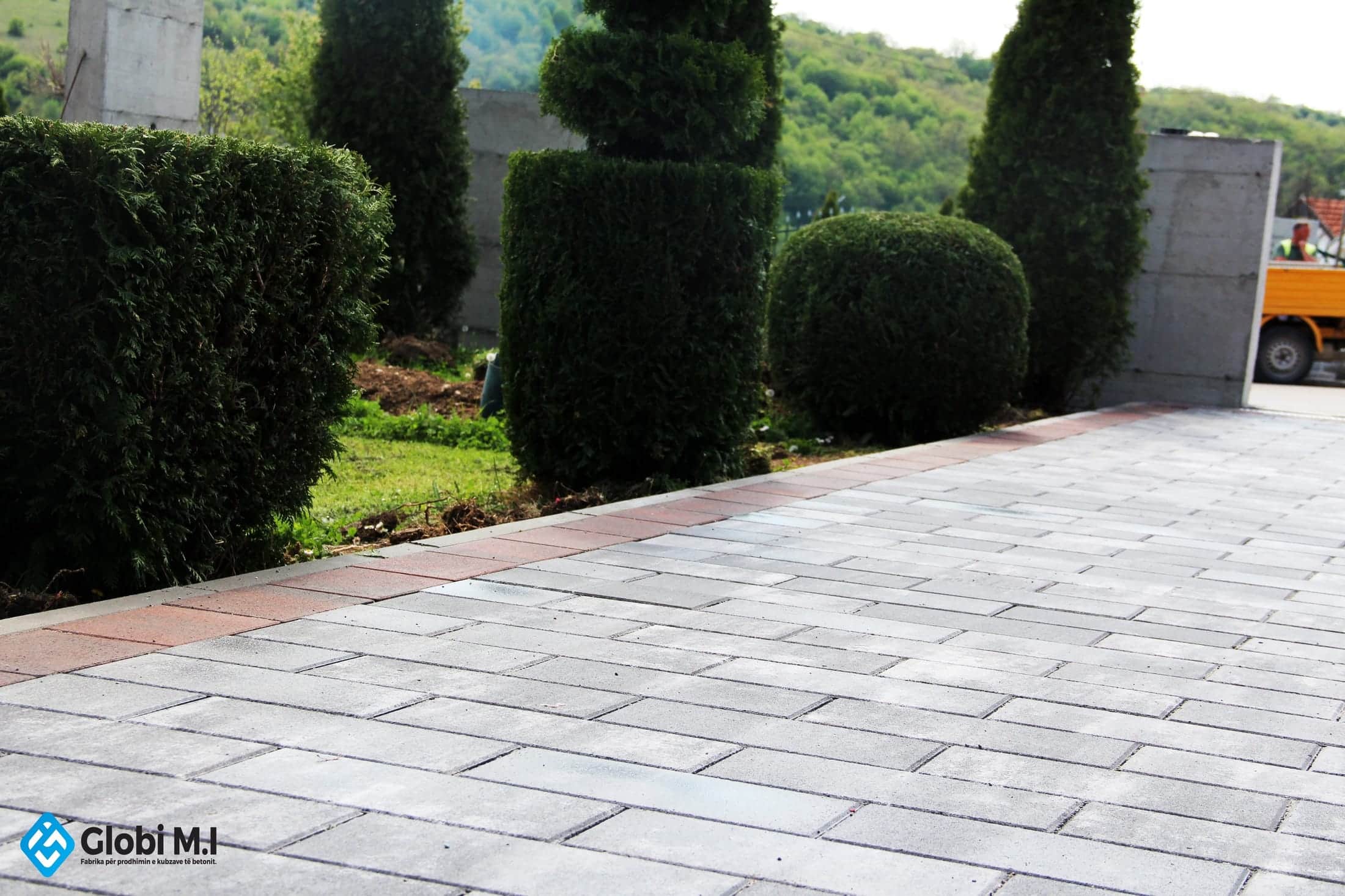 Long paved surface running along the side of a house.