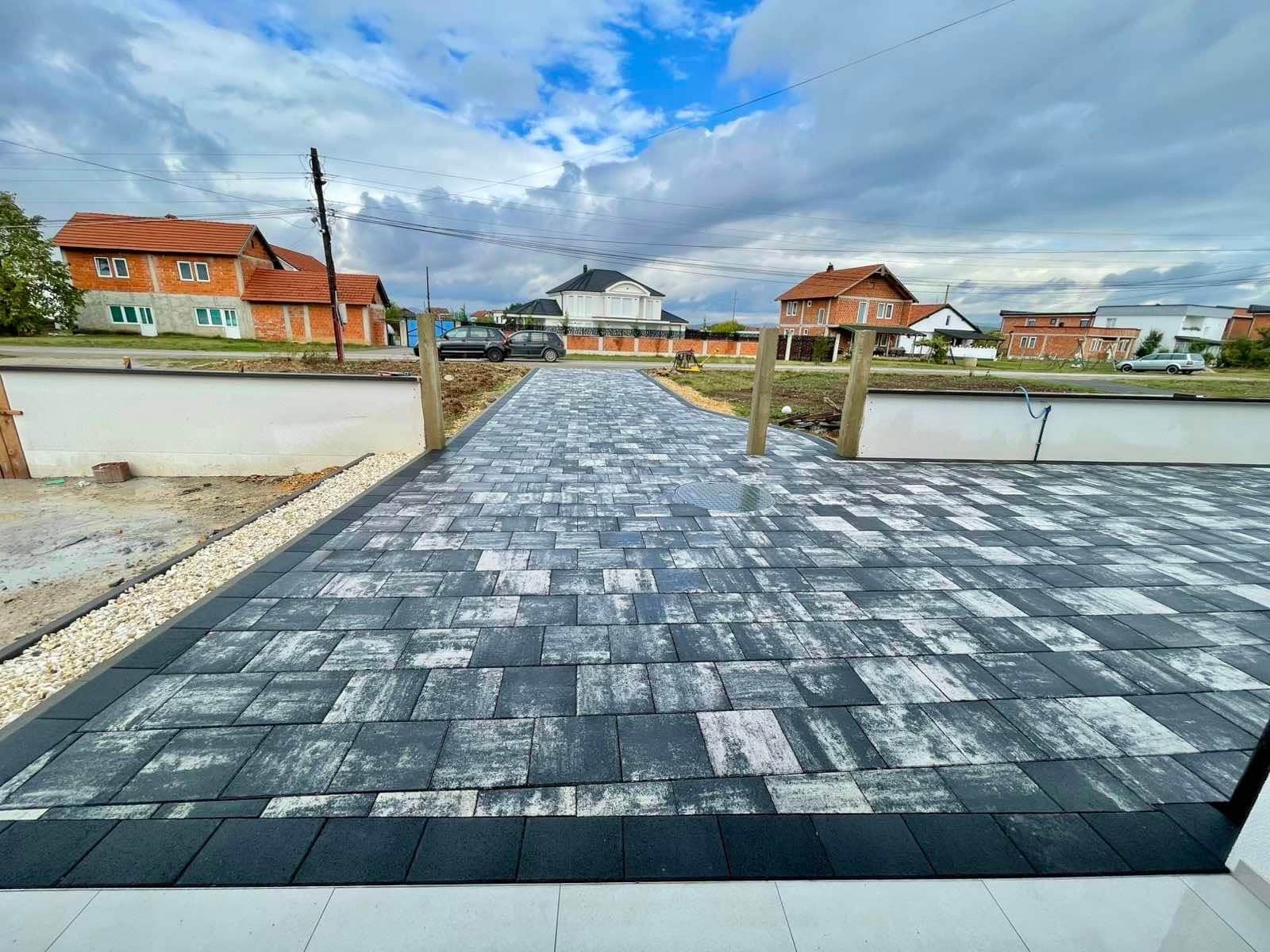 Paved driveway extending from the house toward the street.
