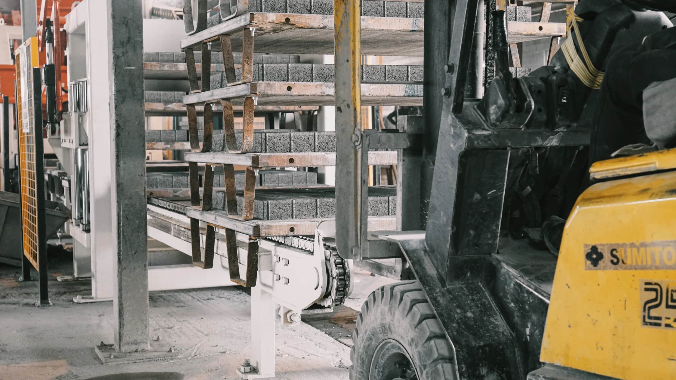 Forklift moving racks of concrete elements