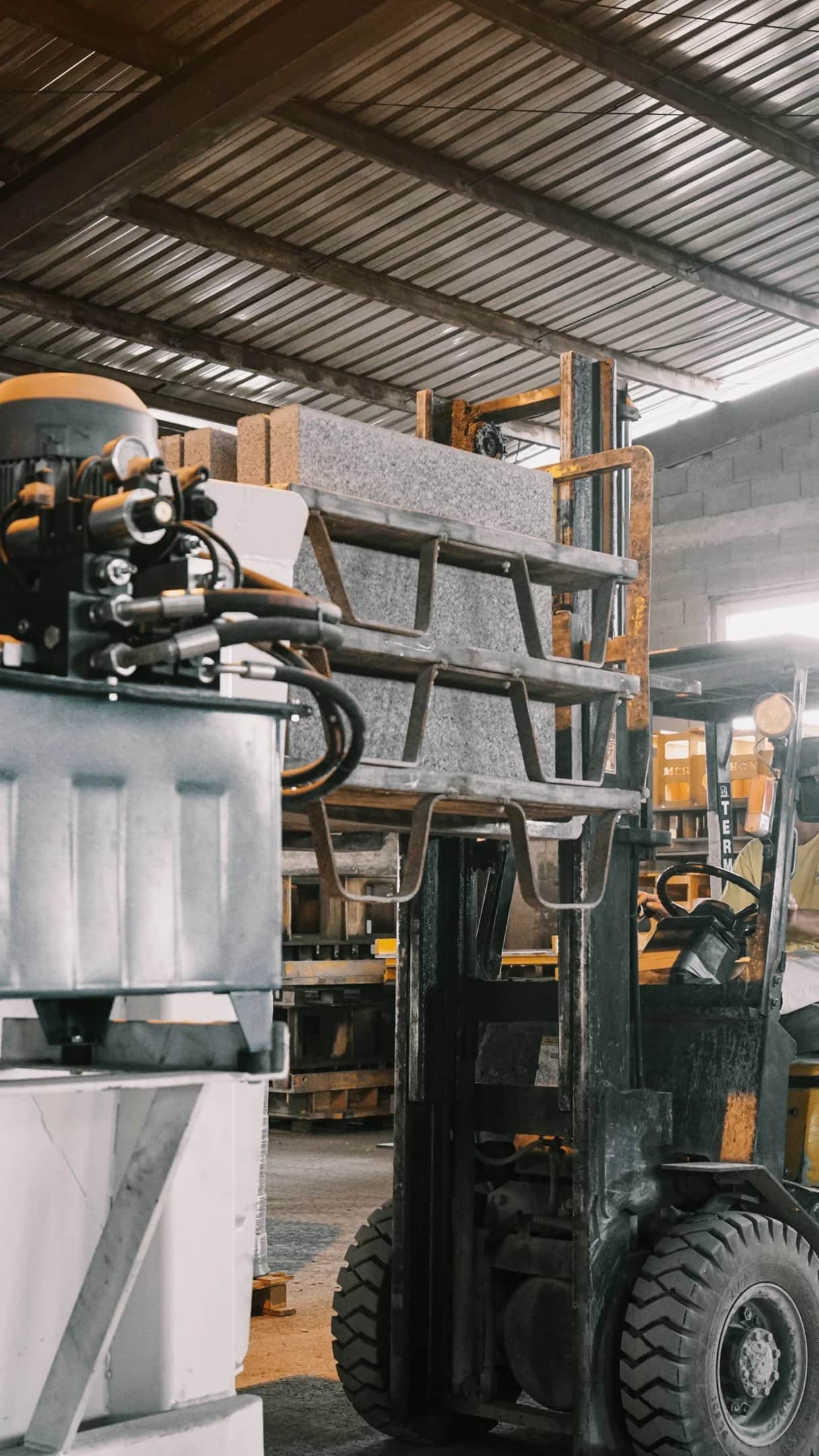 Forklift carrying a pallet of concrete slabs